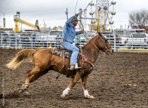 Cowboy racing during a team roping event 