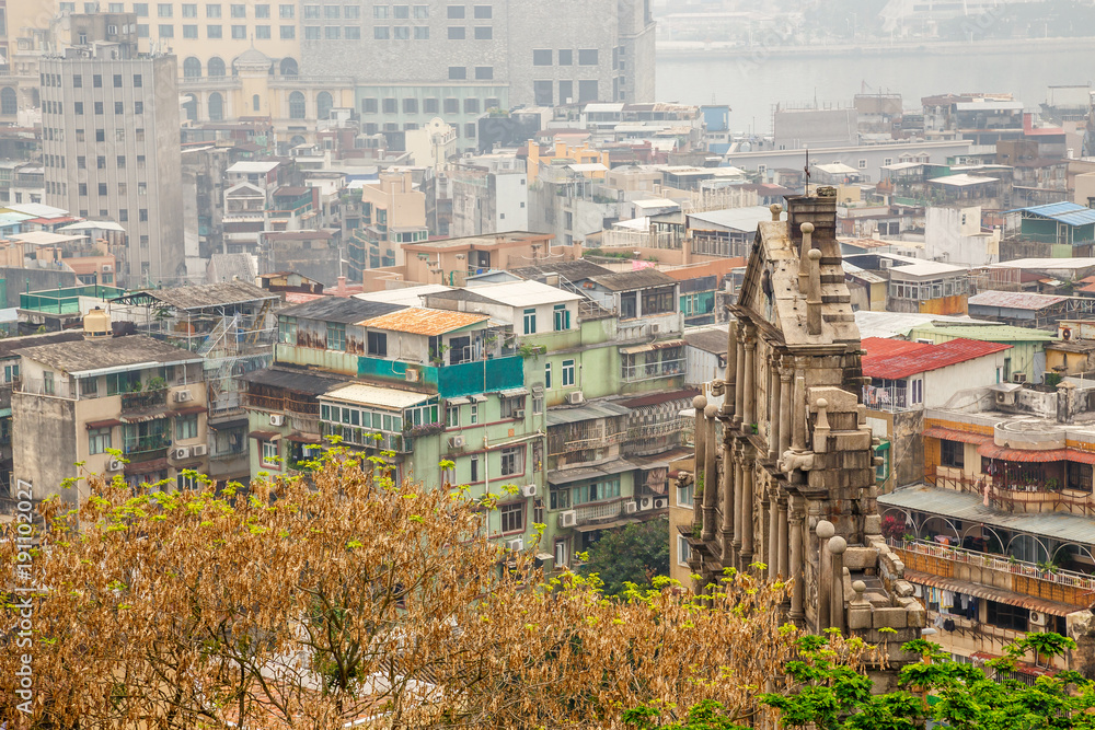Fototapeta premium Ruins of St. Paul's landmark with slum blocks in the background, Macau, China