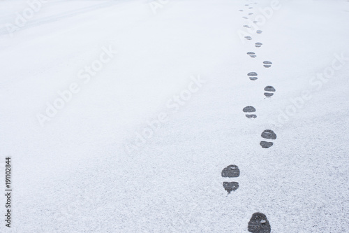 Winter foot steps in the snow on the ground