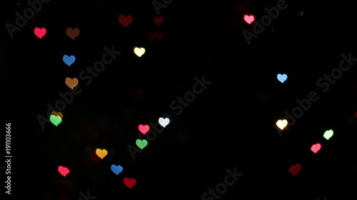 Colored abstract texture for video processing. Creative abstract blur background with a heart bokeh effect. Out of focus, heart lights bokeh, particles background. Saint Valentine animated background