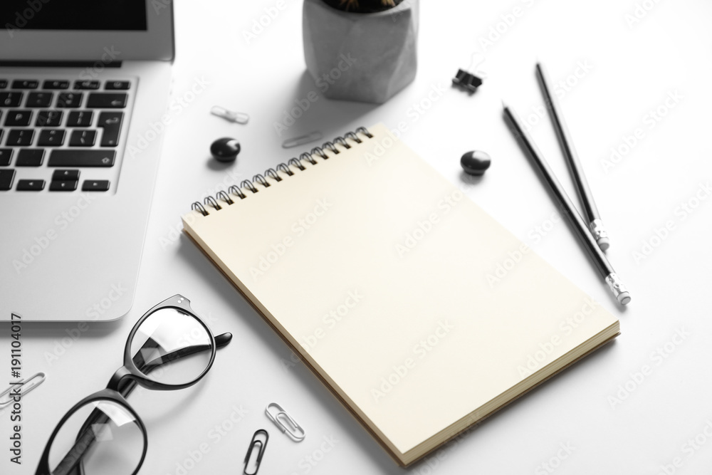 Blank notebook and stationery on white background. Mockup for design Blank notebook and stationery on white background. Mockup for design
