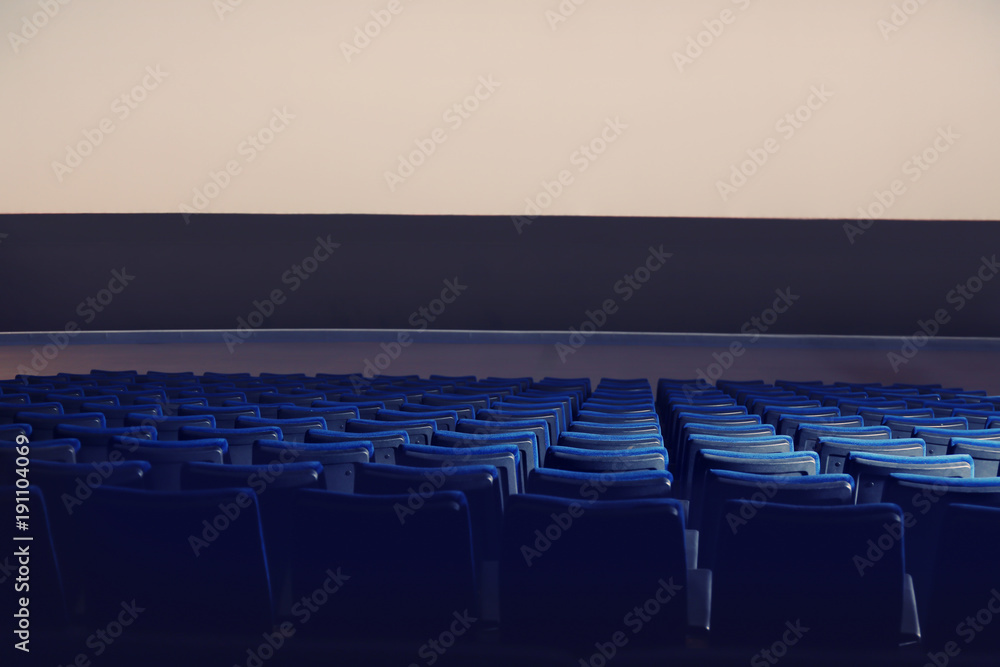 Fototapeta premium Empty cinema with large screen and comfortable chairs