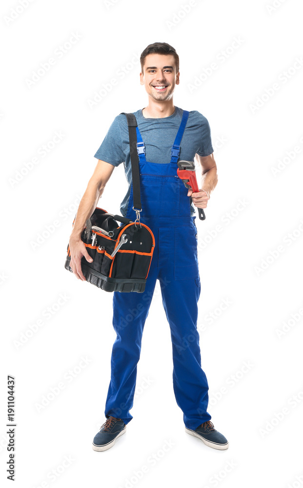 Young plumber in uniform with tool bag and pipe wrench on white background Young plumber in uniform with tool bag and pipe wrench on white background