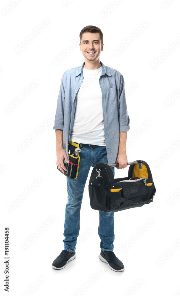 Young plumber with tool belt and bag on white background Young plumber with tool belt and bag on white background