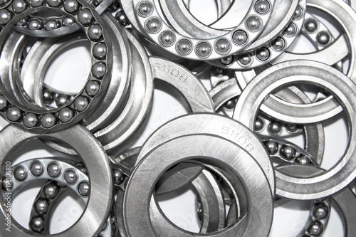 Industrial bearings and ball cages for rolls or wheels on white background
