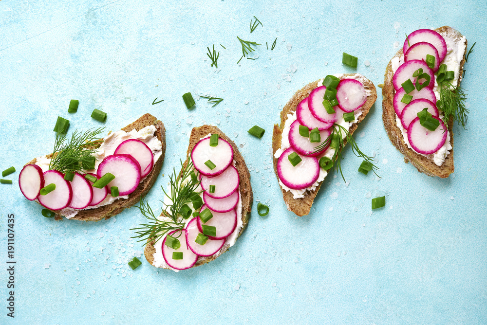Soft Roe Toast Rye toasts with soft cheese, redish and dill.Top view with copy space ...