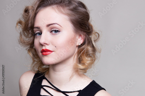Pretty blond girl model like Marilyn Monroe in black dress with red lips on white background. 50's Vintage Fashion and Style. B&W. Portrait of rich young woman, material girl, femme fatale