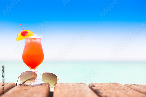 Fototapeta Naklejka Na Ścianę i Meble -  glass of delicious sex on the beach cocktail by the sea