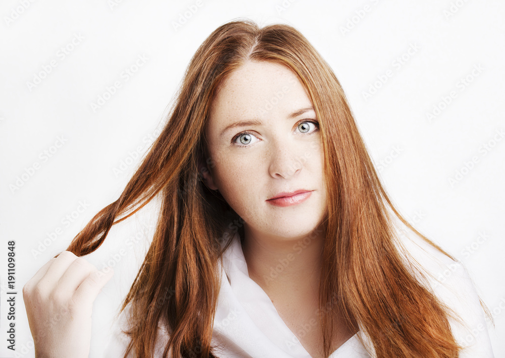 Beautiful young redhead woman with freckles portrait isolated on white