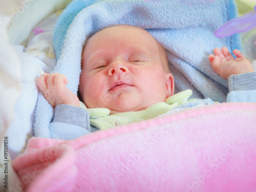 Little newborn baby sleeping calmly in blanket