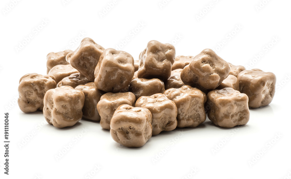 Milk chocolate coconut cubes stack isolated on white background.