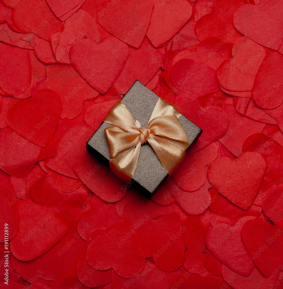 gift box on the background of paper hearts gift box on the background of paper hearts