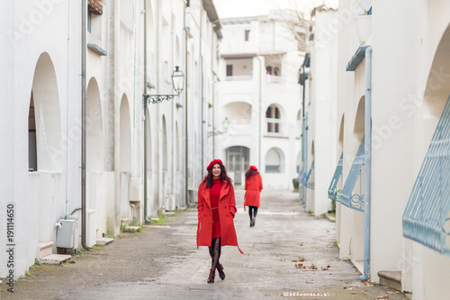 women in red walking down the street