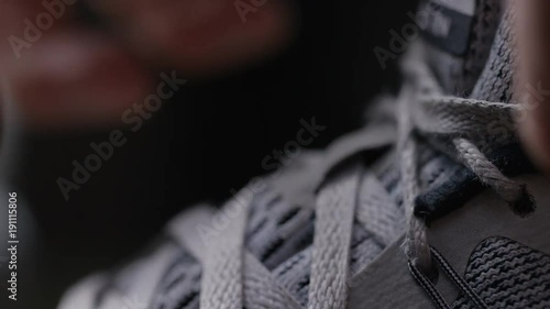 Close up of shoe laces on sports shoes being tied up
