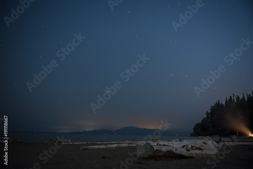 Shooting star over beach and mountains © Braeden