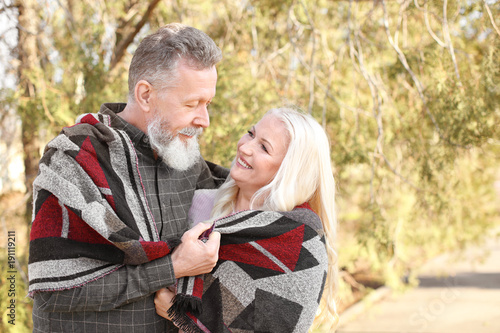Happy mature couple in autu...