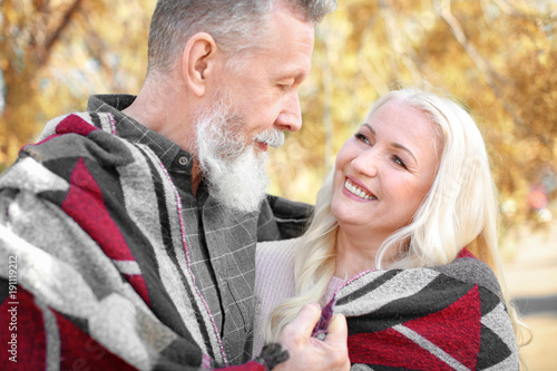 Happy mature couple in autu...