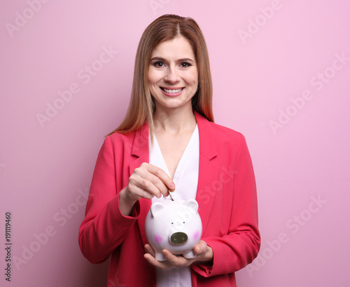 Young woman putting coin in...