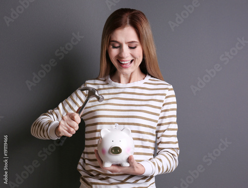 Young woman holding hammer ...