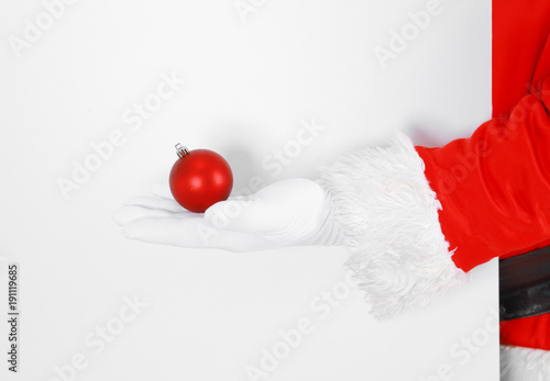 Real Santa Claus holding christmas ball, isolated on white background.