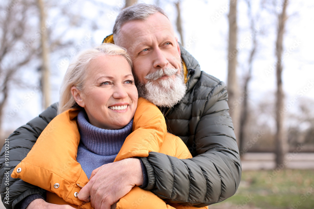Happy mature couple hugging outdoors Happy mature couple hugging outdoors