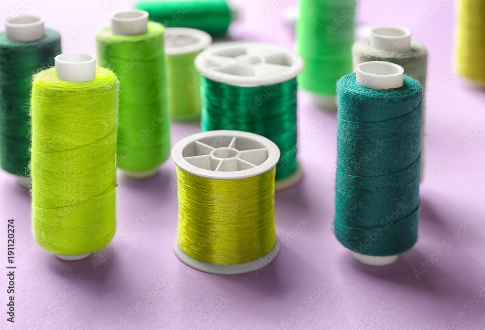 Set of sewing threads on color background Set of sewing threads on color background