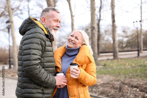 Happy mature couple with co...