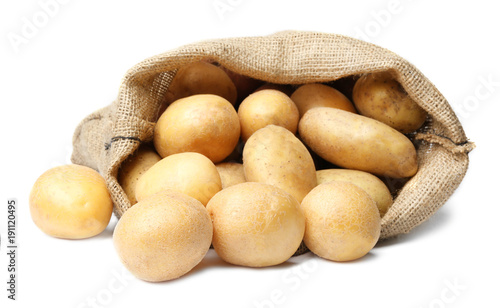 Sack of fresh raw potatoes on white background