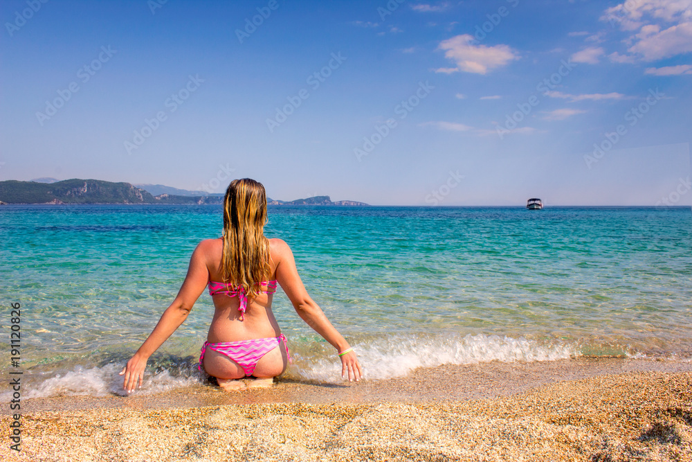 Beautiful plus size girl enjoying summer vecation at Ionian sea beach.