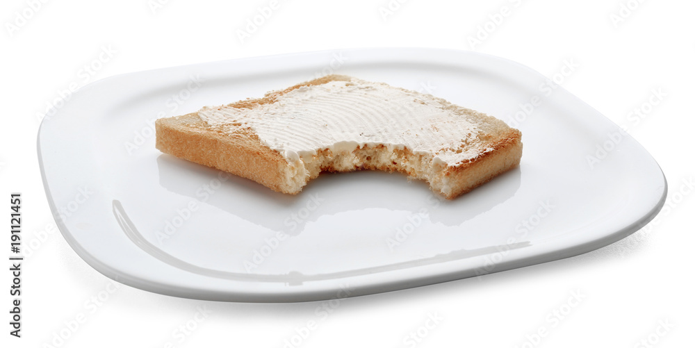Toasted bread with bite mark on plate against white background Toasted bread with bite mark on plate against white background