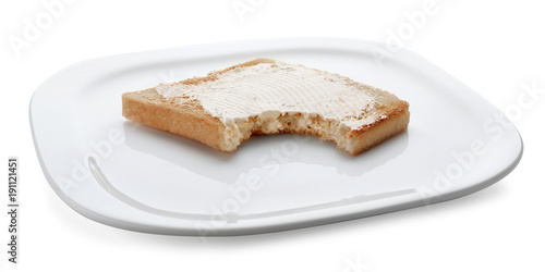 Toasted bread with bite mark on plate against white background