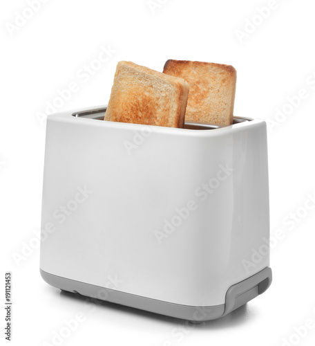 Slices of bread in toaster against white background
