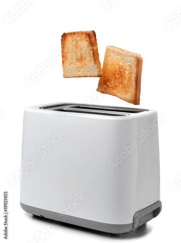 Slices of bread popping out of toaster against white background