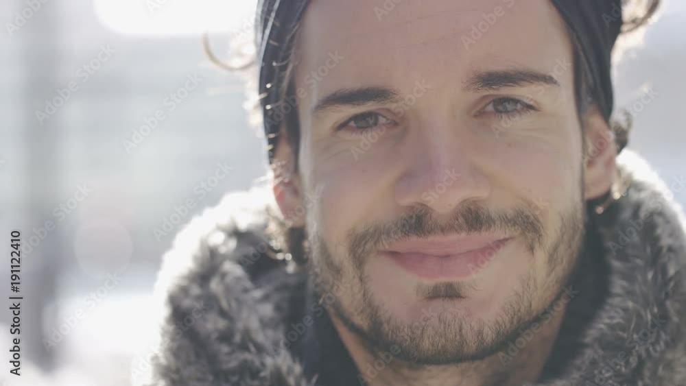 Portrait of handsome man turning and smiling to camera, in slow motion Portrait of handsome man turning and smiling to camera, in slow motion