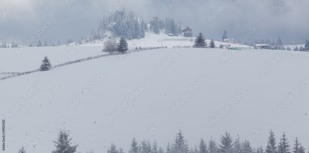 winter in the mountains - small Romanian village in the Carpathians covered with snow winter in the mountains - small Romanian village in the Carpathians covered with snow