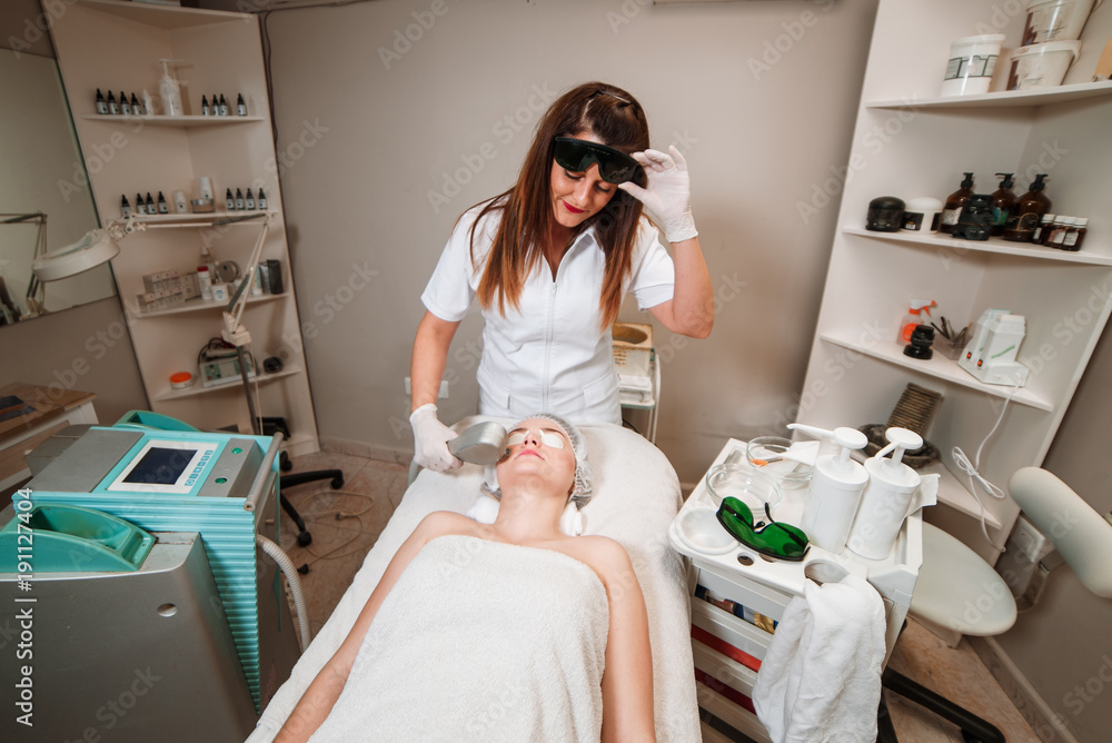Young woman receiving laser treatment Young woman receiving laser treatment