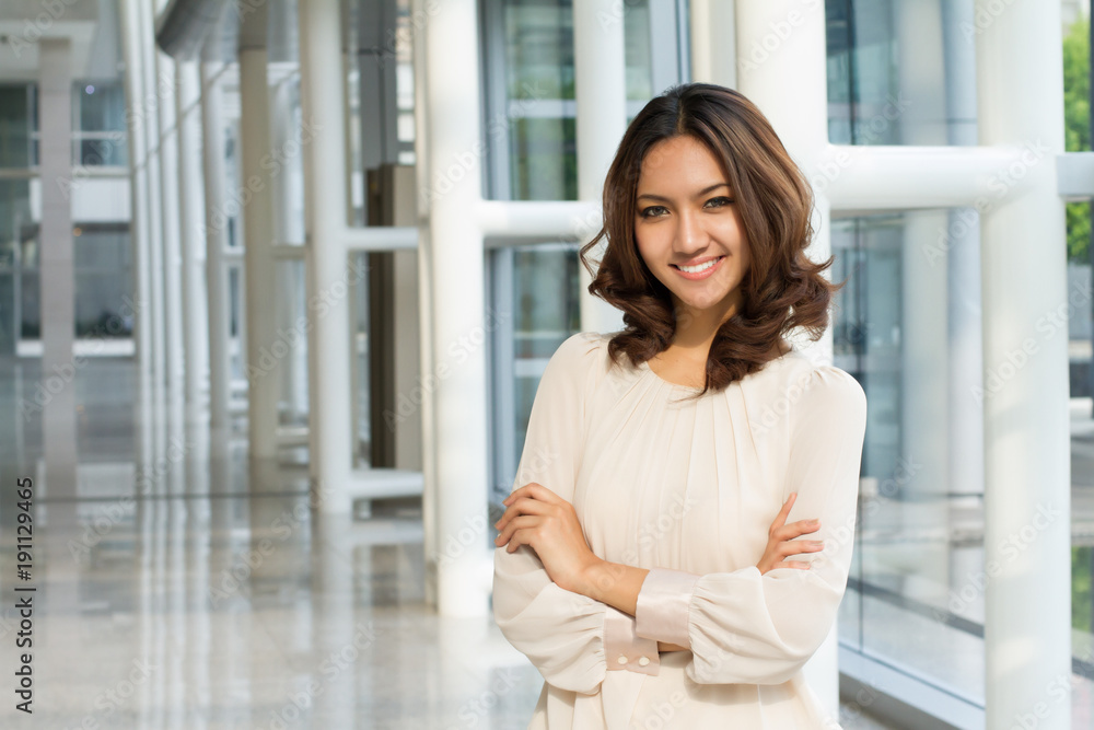 happy smiling confident woman portrait, arm crossed in office building happy smiling confident woman portrait, arm crossed in office building