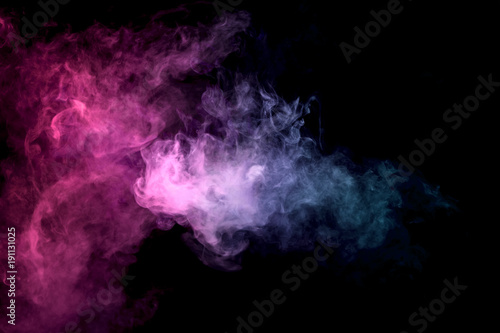 Thick colorful smoke of purle and pink on a black isolated background. Background from the smoke of vape