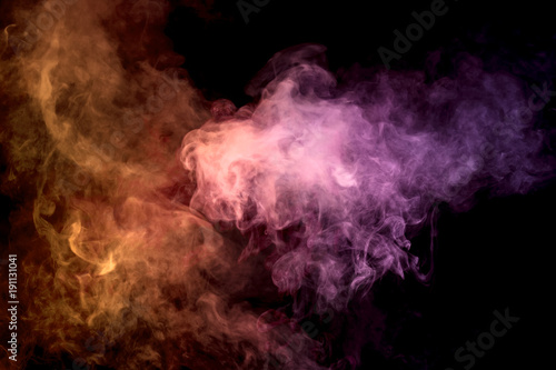 .Colorful orange and pink smoke clouds on dark background.Background of smoke vape.