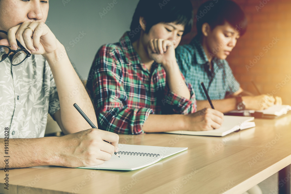 Asian young man,Homosexuality or woman holding pencil exam,examination in classroom . Tutor books with friends. Young students helps friend and learning. People, learning, education. Asian young man,Homosexuality or woman holding pencil exam,examination in classroom . Tutor books with friends. Young students helps friend and learning. People, learning, education.