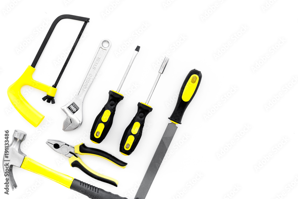Tools for repair and building. File, saw, hummer on white background top view copy space Tools for repair and building. File, saw, hummer on white background top view copy space