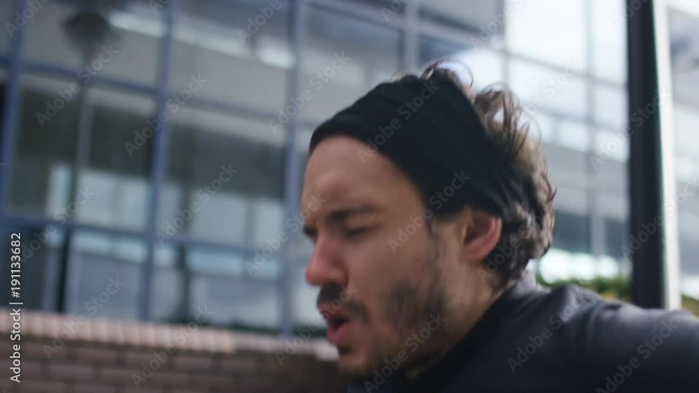 Focused man doing tricep dips outdoors in the city Focused man doing tricep dips outdoors in the city