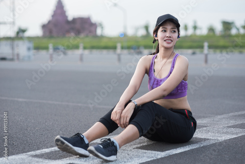 Young woman runner is jogging on the street be running for exercise. © Suntipong