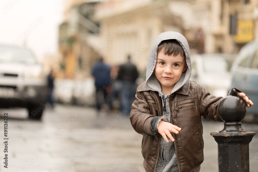 Young boy running around street pole Young boy running around street pole