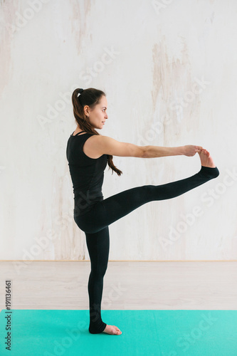 Fototapeta Naklejka Na Ścianę i Meble -  Young beautiful woman practicing yoga and gymnastic. Wellness concept. Classes in single sports.
