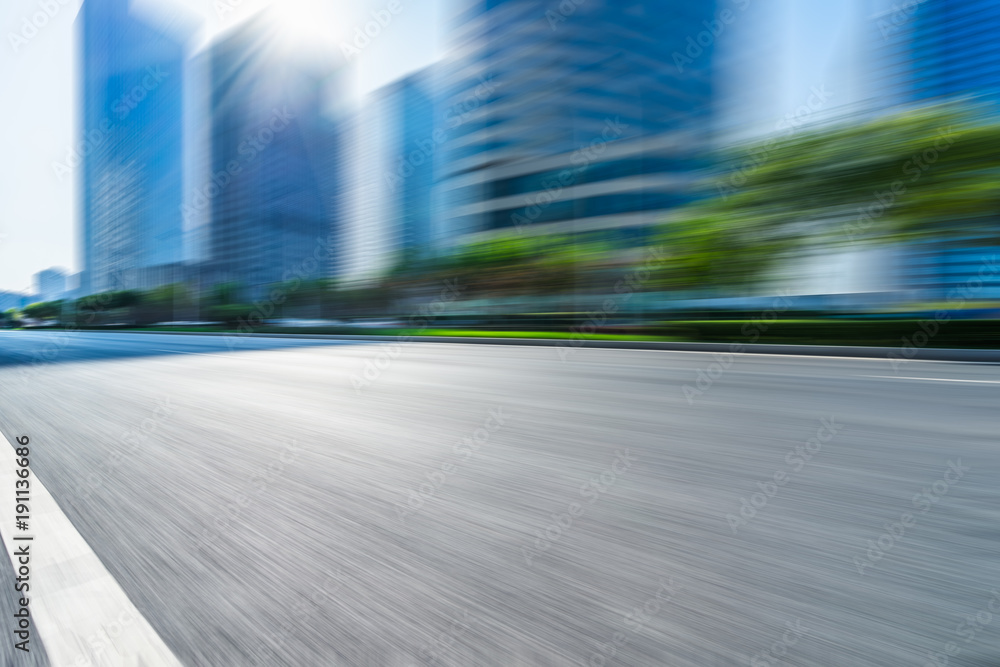 blurred urban road with city skyline background in china. blurred urban road with city skyline background in china.
