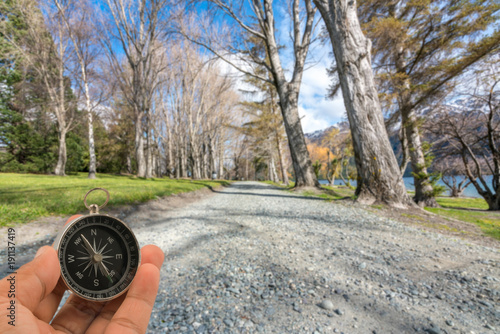 Compass with natural blur background. Travel concept. photo