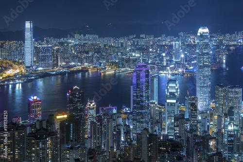 Aerial view of Victoria Harbor of Hong Kong city at night © leeyiutung