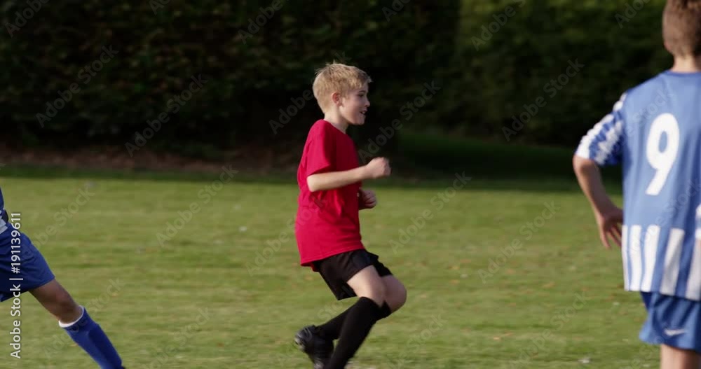 Children's soccer team on the field. Shot in slow motion on RED Epic. Children's soccer team on the field. Shot in slow motion on RED Epic.