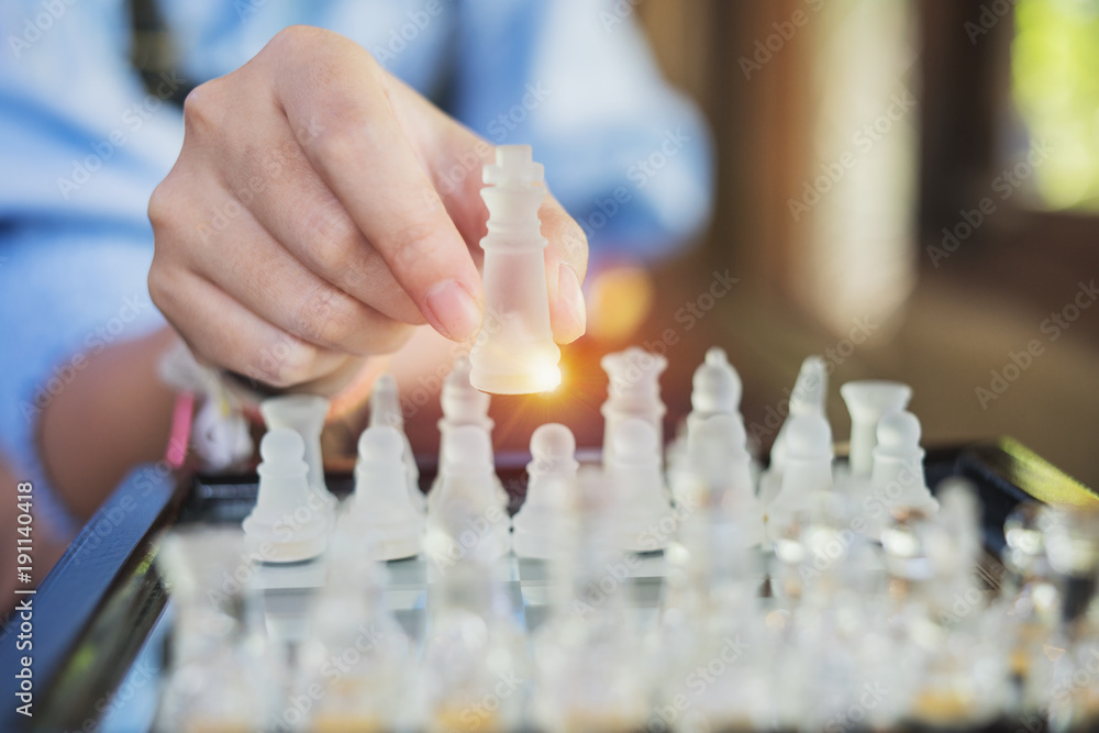 Hand of businesswoman playing chess Hand of businesswoman playing chess